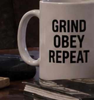 A coffee mug printed GRIND OBEY REPEAT.